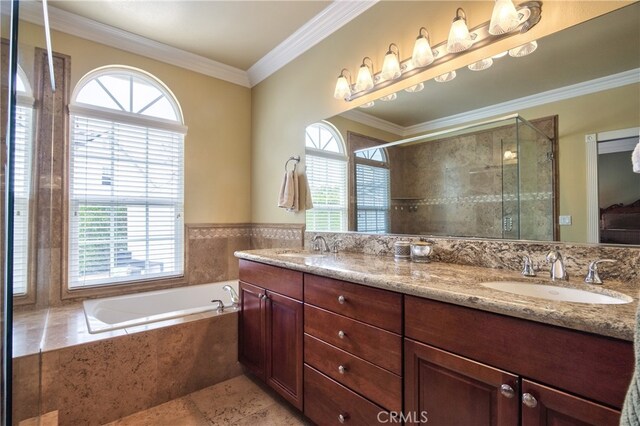 bathroom with ornamental molding, independent shower and bath, and a wealth of natural light