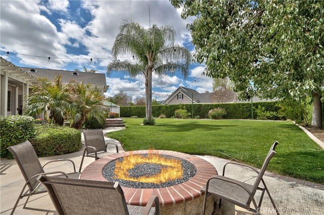 view of patio / terrace with an outdoor fire pit