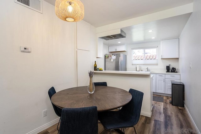 dining room with dark hardwood / wood-style floors