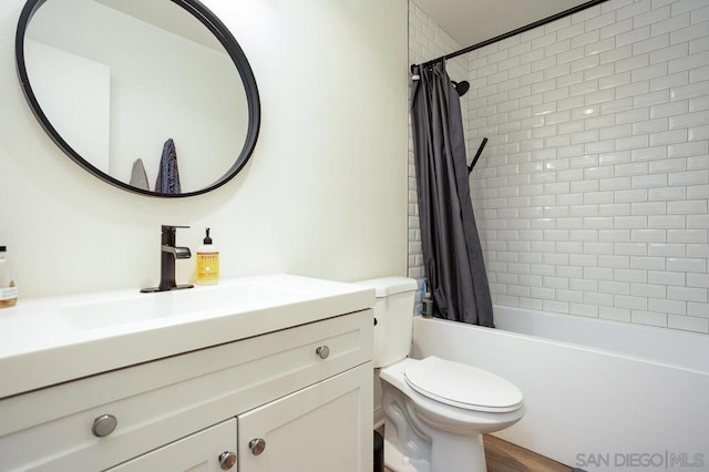 full bathroom with vanity, shower / tub combo, and toilet