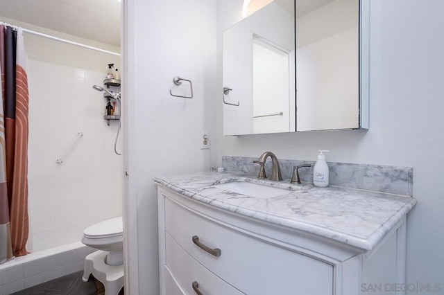 bathroom featuring vanity, a shower with curtain, and toilet