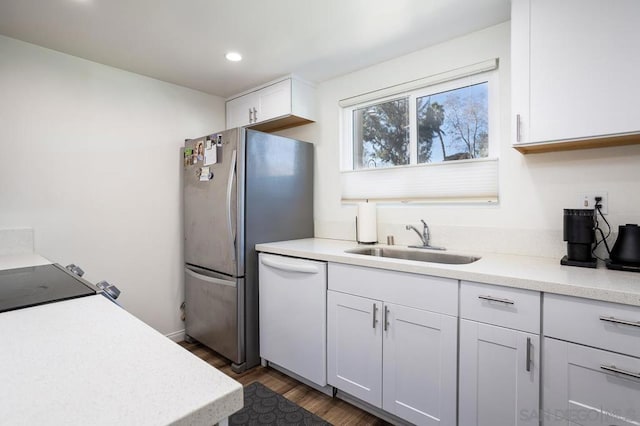 kitchen with white cabinetry, dishwasher, sink, and dark wood-type flooring