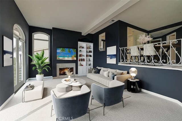 living room with beamed ceiling and carpet flooring