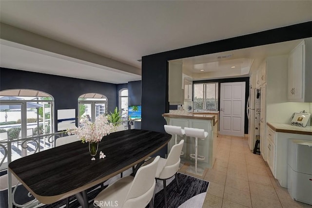 dining space featuring light tile patterned floors