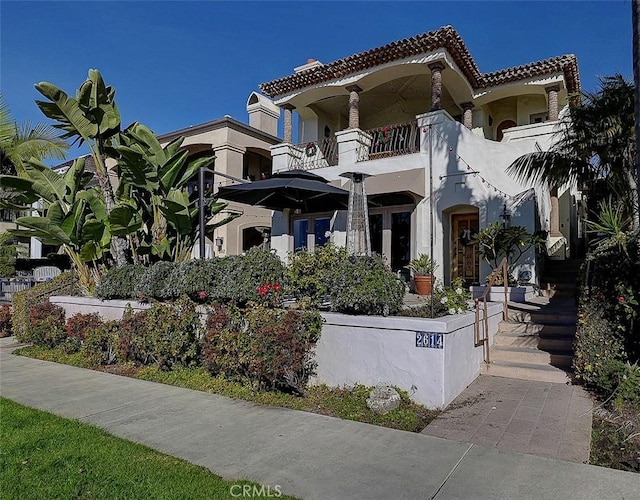 2614 Ocean Blvd, Corona Del Mar, CA 92625 - view of front of home with a tile roof, a balcony, and stucco siding