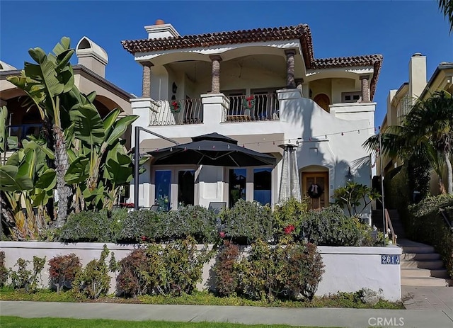 mediterranean / spanish home featuring a balcony