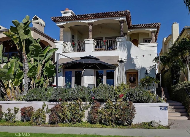 2614 Ocean Blvd, Corona Del Mar, CA 92625 - back of property with a balcony, stucco siding, a tiled roof, and a chimney