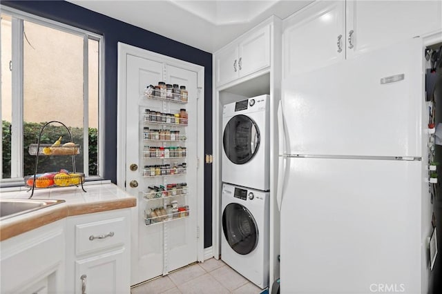 2614 Ocean Blvd, Corona Del Mar, CA 92625 - laundry room featuring stacked washer / dryer and light tile patterned floors