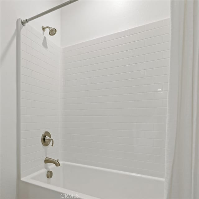 bathroom with shower / bath combination with curtain