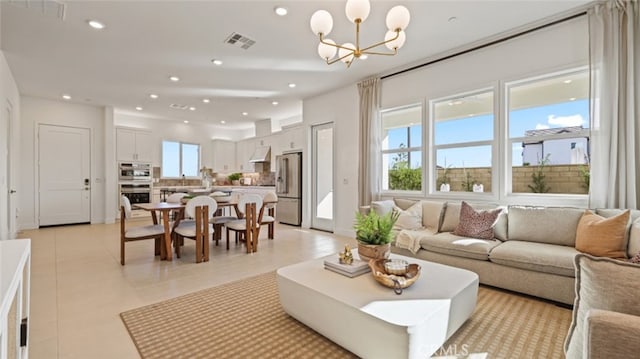 living room featuring a chandelier and light tile patterned floors