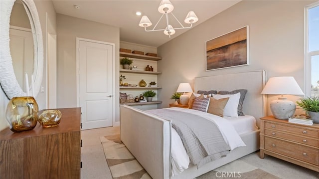 carpeted bedroom featuring a chandelier