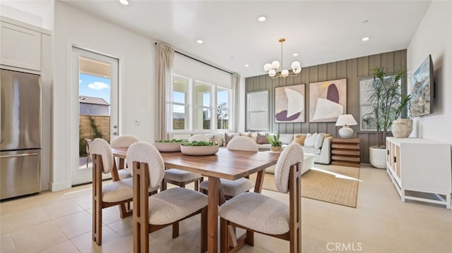 tiled dining area featuring a chandelier