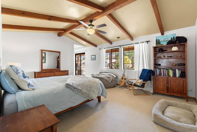 bedroom featuring ceiling fan, lofted ceiling with beams, and carpet