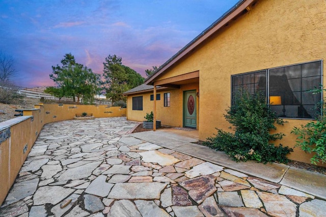 view of patio terrace at dusk