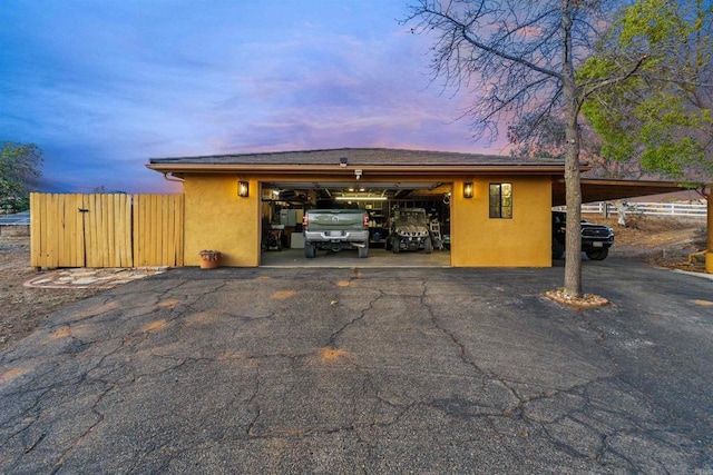 view of garage at dusk