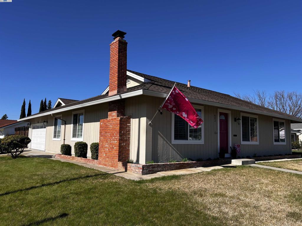 exterior space featuring a garage and a yard