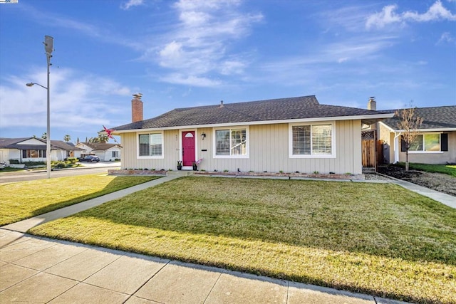 ranch-style house featuring a front lawn