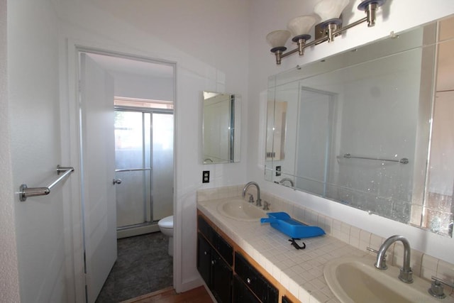 bathroom with vanity, toilet, and walk in shower