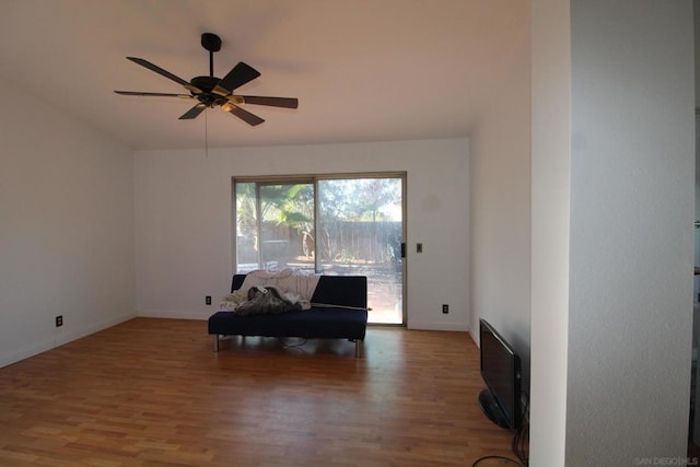 living area featuring ceiling fan and wood-type flooring