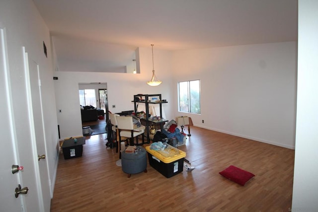 dining space featuring dark hardwood / wood-style flooring and high vaulted ceiling