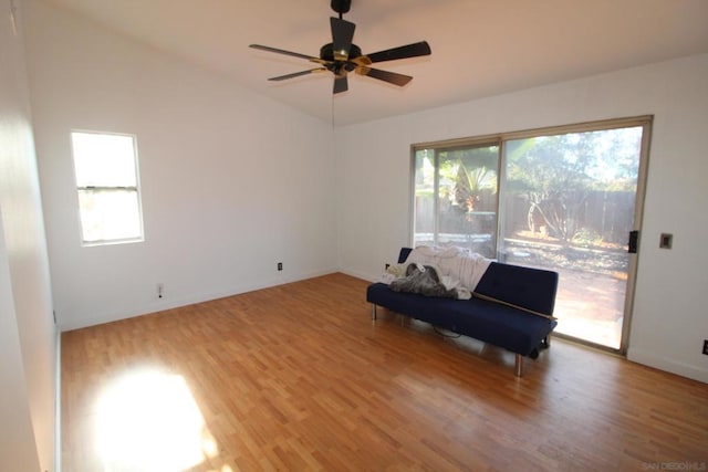 unfurnished room with lofted ceiling, wood-type flooring, and ceiling fan