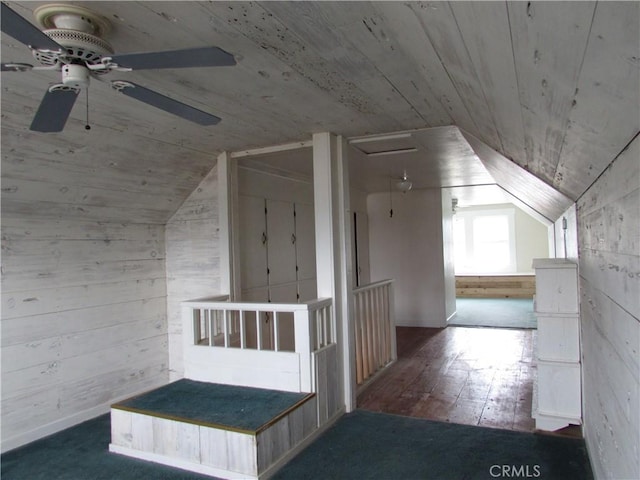 bonus room with wood ceiling, wooden walls, dark hardwood / wood-style flooring, and vaulted ceiling