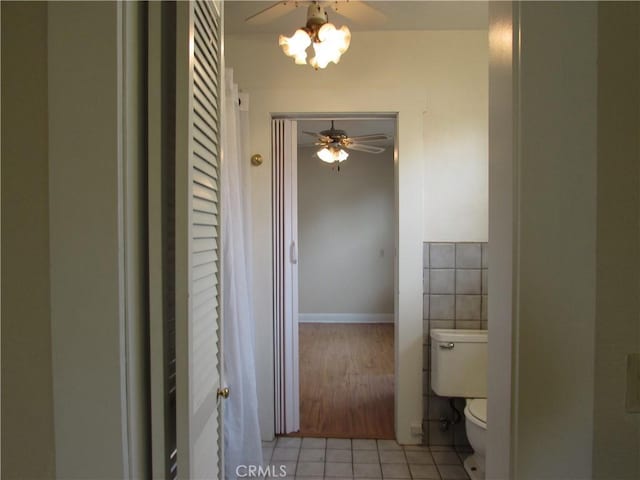 bathroom featuring tile patterned flooring, toilet, and ceiling fan