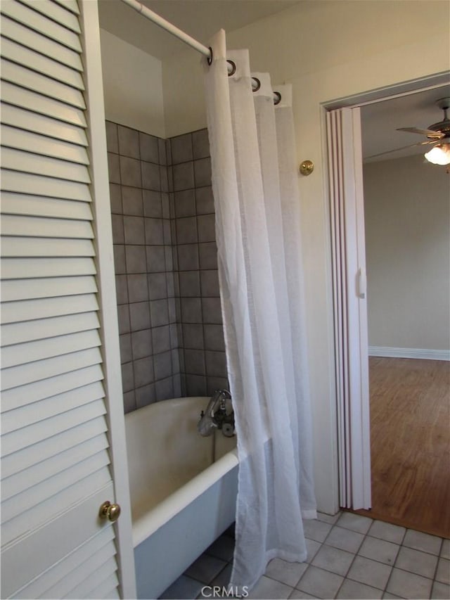 bathroom featuring tile patterned flooring, shower / bath combination with curtain, and ceiling fan