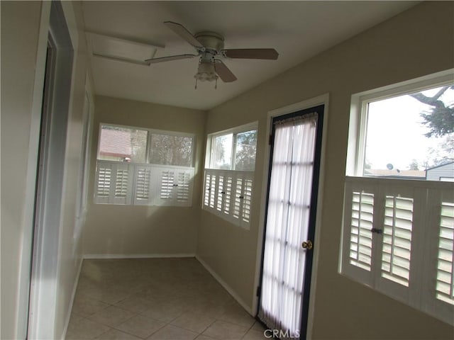 unfurnished sunroom with a healthy amount of sunlight and ceiling fan