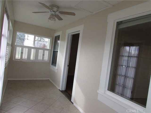 unfurnished sunroom with ceiling fan