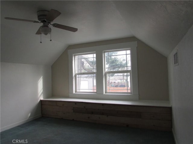 bonus room featuring dark colored carpet, vaulted ceiling, and a wealth of natural light