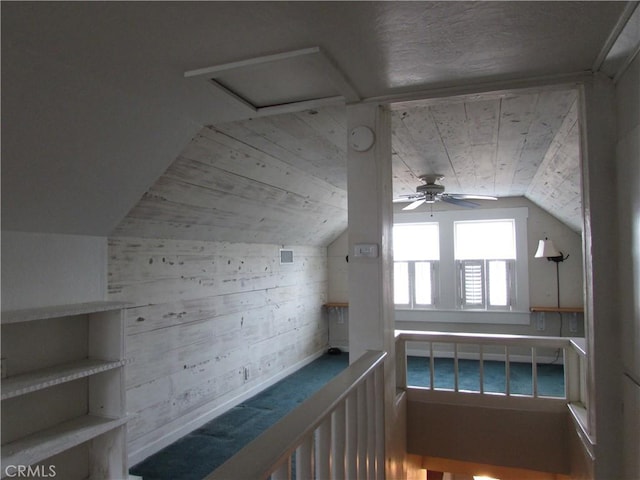 additional living space featuring lofted ceiling, wooden ceiling, and wood walls