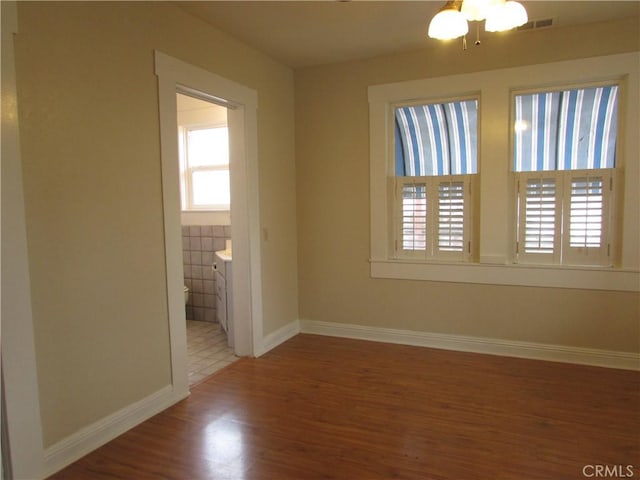 unfurnished room with hardwood / wood-style flooring