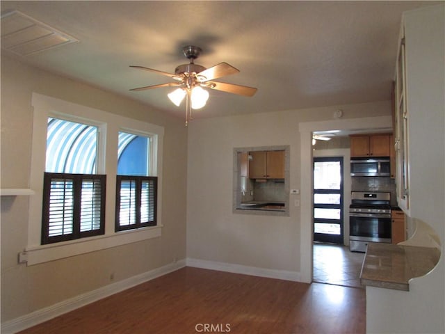 interior space with hardwood / wood-style flooring and ceiling fan