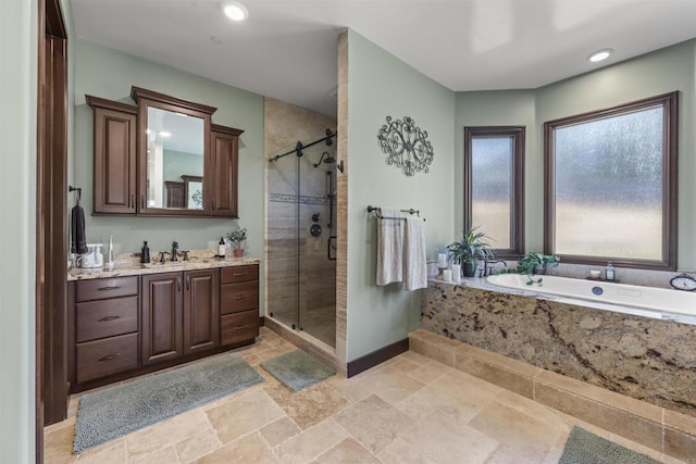 bathroom with shower with separate bathtub and vanity