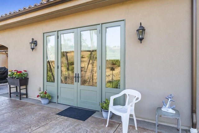 property entrance with french doors and a patio