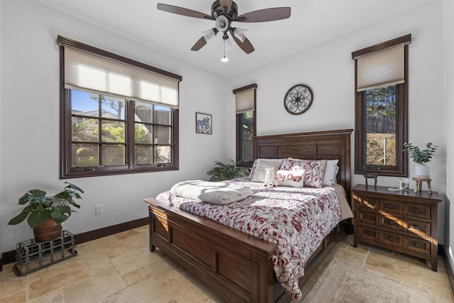 bedroom featuring multiple windows and ceiling fan