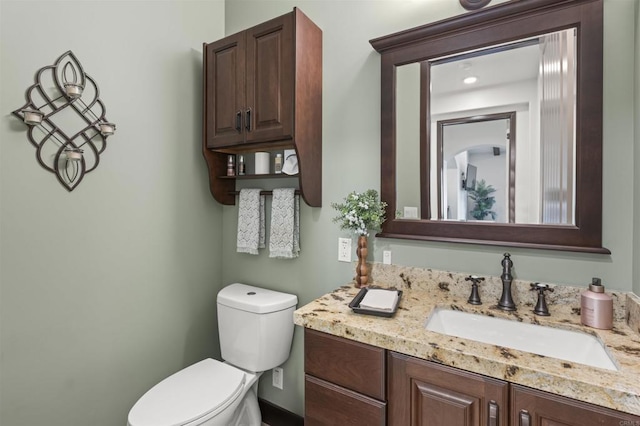 bathroom featuring vanity and toilet