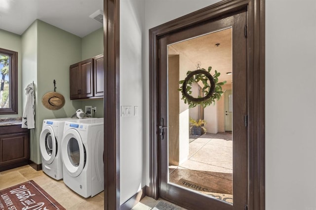 laundry area featuring independent washer and dryer and cabinets