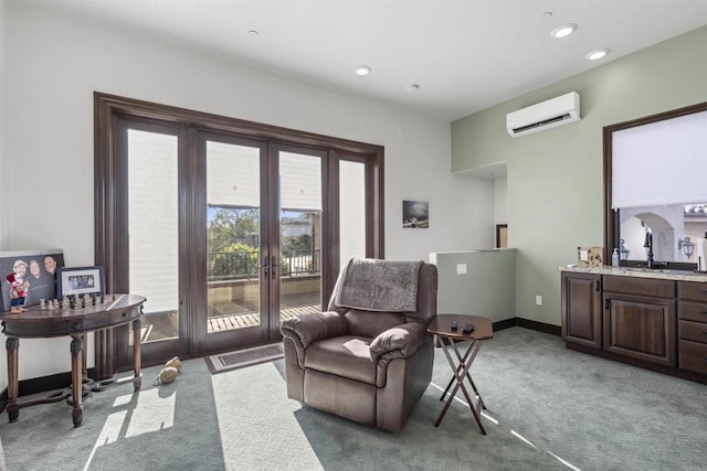 living area with french doors, a wall mounted air conditioner, sink, and carpet floors