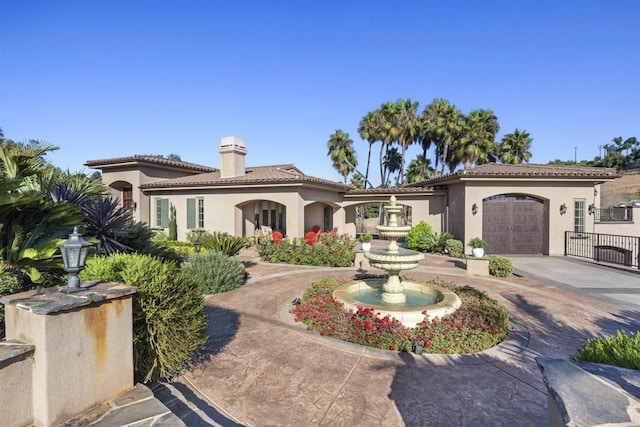 mediterranean / spanish house featuring a garage