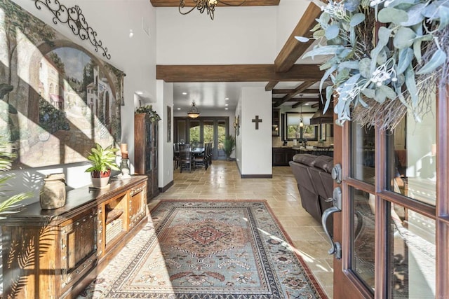 entryway with beamed ceiling and a notable chandelier