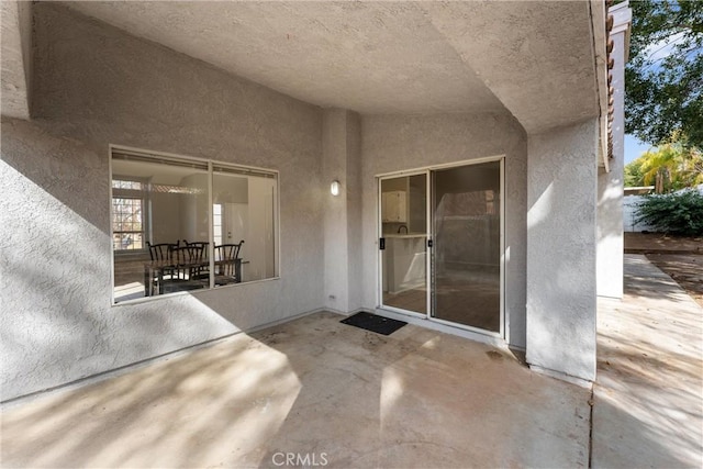 doorway to property with a patio area