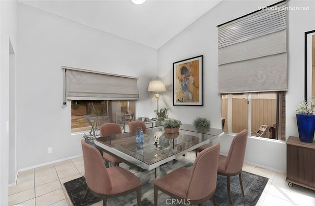 dining room featuring light tile patterned flooring and lofted ceiling