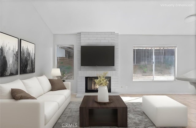 living room featuring lofted ceiling and a fireplace