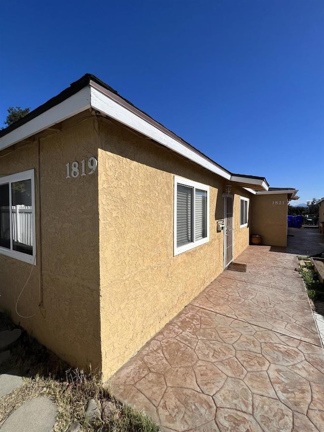 view of property exterior with a patio