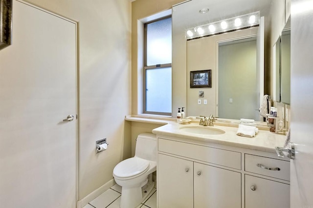 bathroom with tile patterned flooring, vanity, and toilet