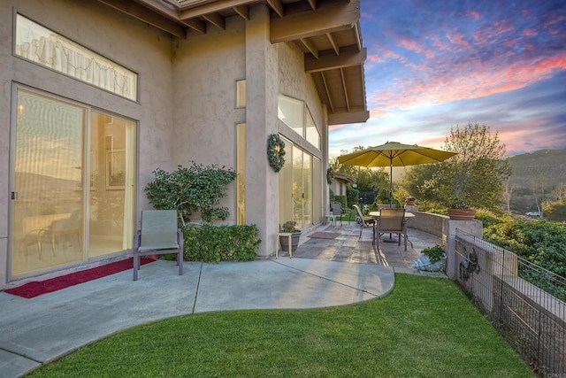 patio terrace at dusk with a yard