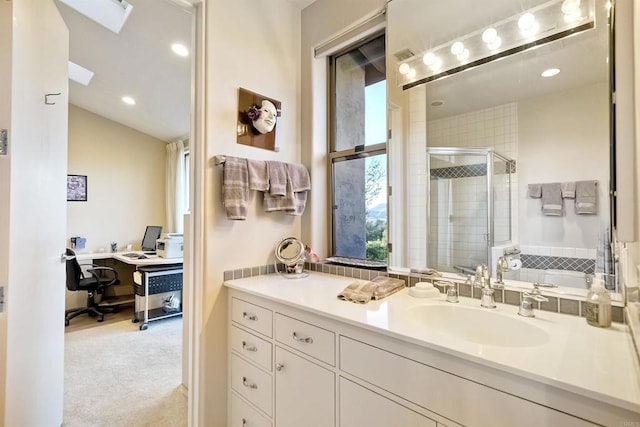 bathroom featuring vanity, vaulted ceiling, and walk in shower