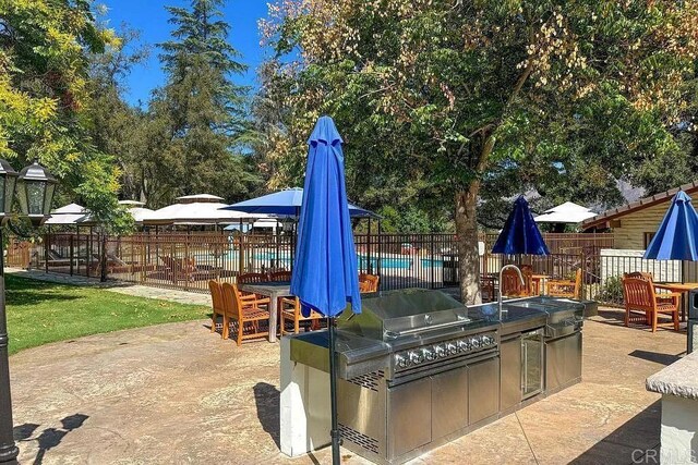 15615 Pauma Valley Dr, Pauma Valley, CA 92061 - view of patio featuring exterior kitchen and a community pool
